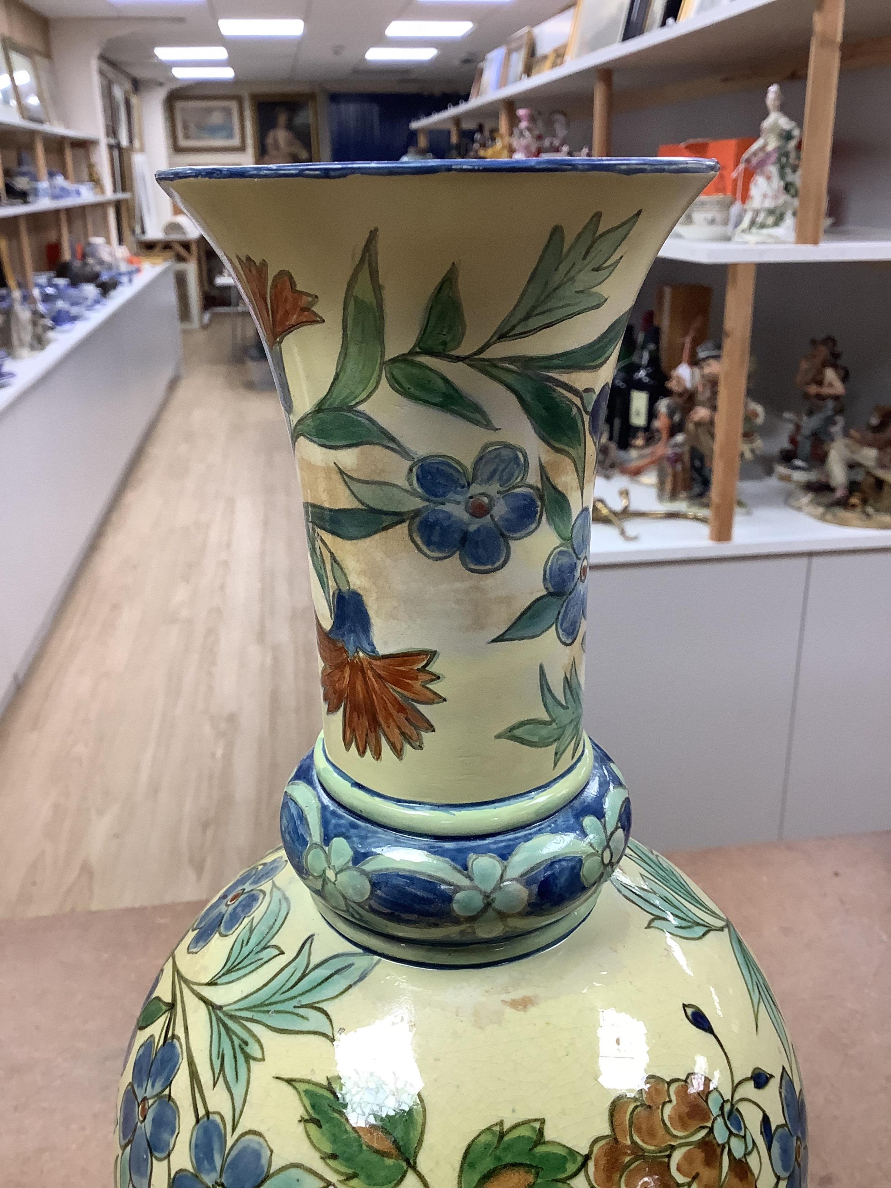 A pair of Doulton Lambeth Persian inspired faience vases, dated 1877, restored, 37cm high